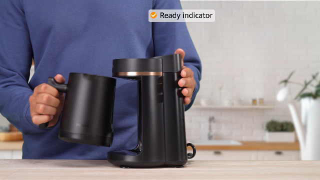 a man use the Philips Series 5000 Turkish Coffee Maker, 735 Watt, Black Copper - HDA150/60