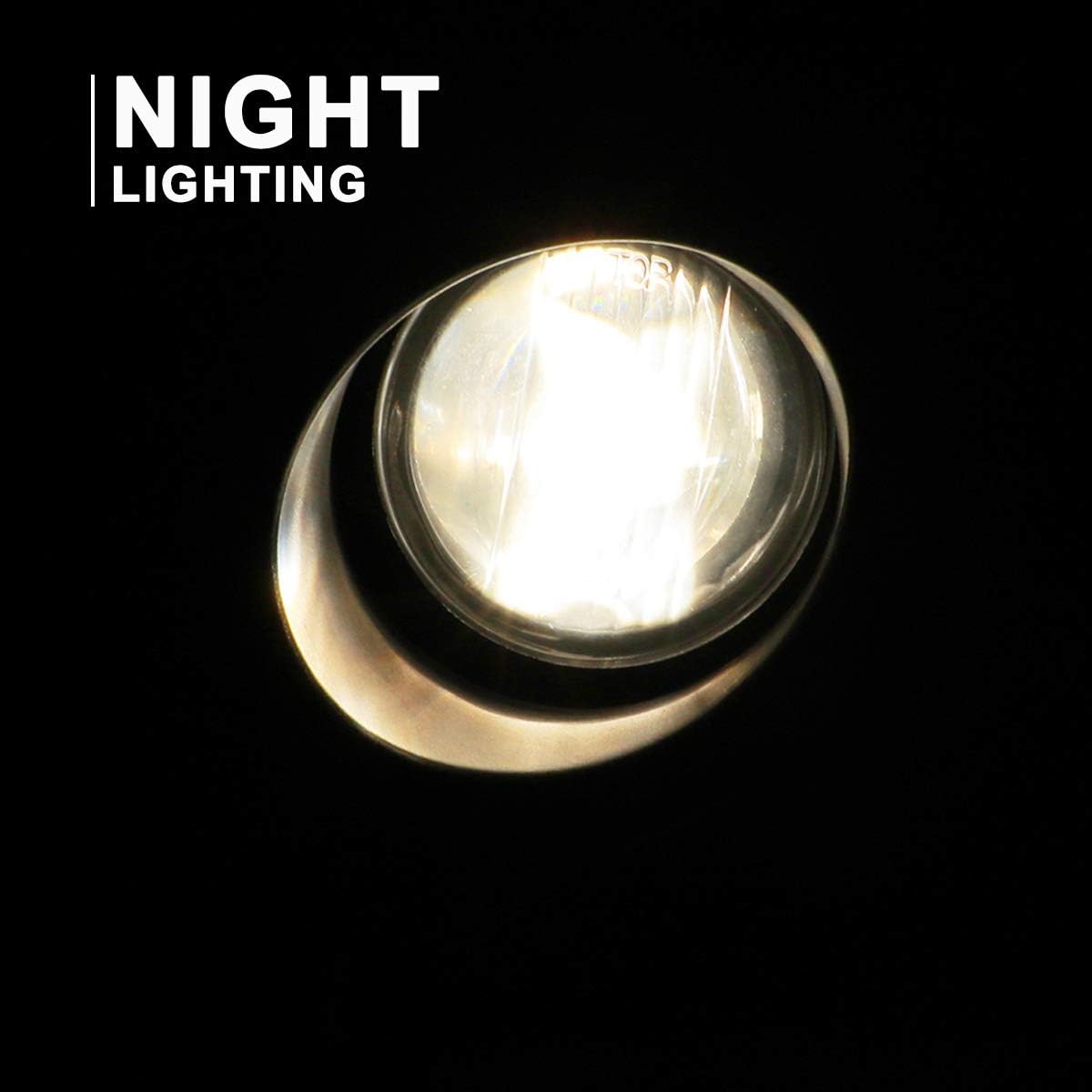 Akaiky view of an illuminated fog light at night, showing its bright, focused beam.