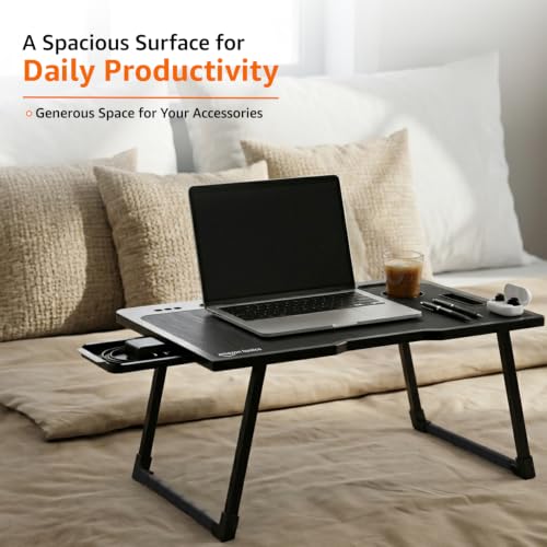 Image of Amazon Basics Engineered Wood Foldable Laptop Table with Cup and Pen Holder, Tablet and Mobile Phone Groove | Mini Drawer, Use for Writing, Bed, Breakfast (60L x 40W x 25H cm, Black)