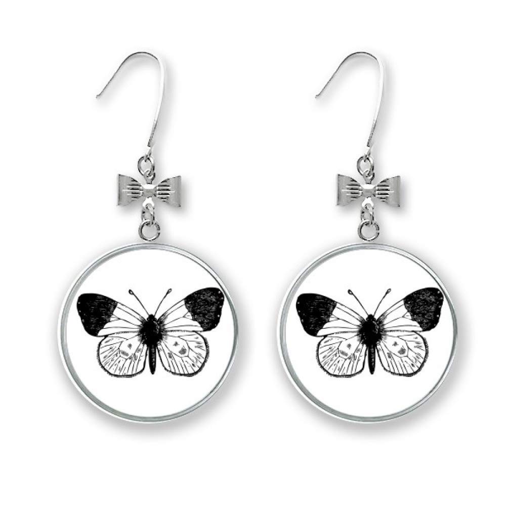 Boucles d'oreilles nœud papillon à ailes blanches et finitions luxe