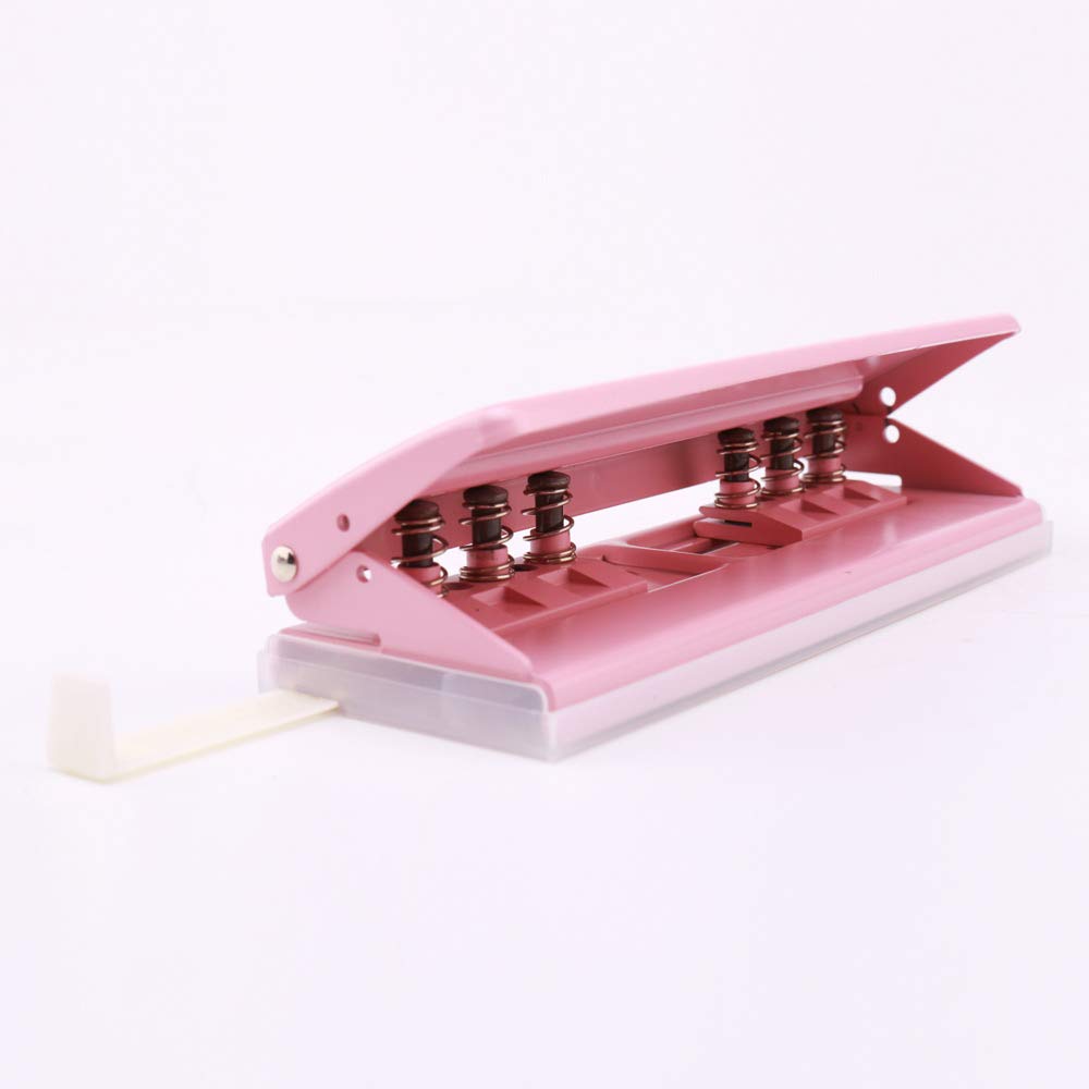 Hand pressing down on the pink 6-hole punch with paper inserted