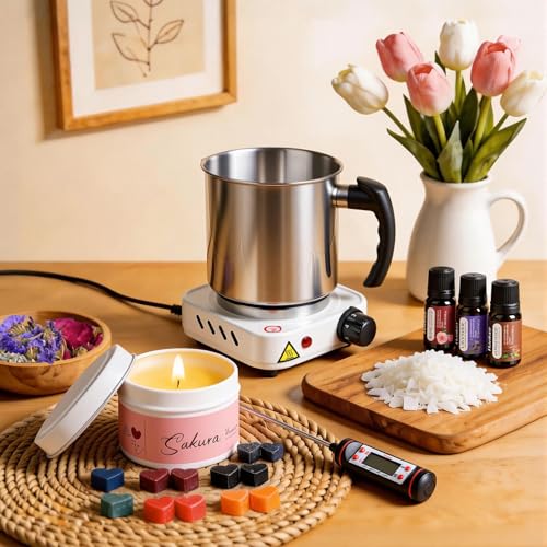 Candle-making setup with melting pot, hot plate, thermometer, wax flakes, fragrance oils and finished candle.