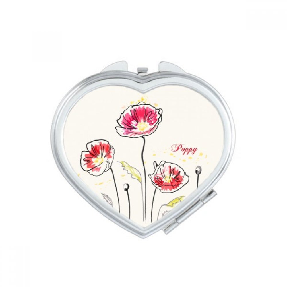Miroir de poche à la main fleurs de pavot pour retouches beauté en voyage