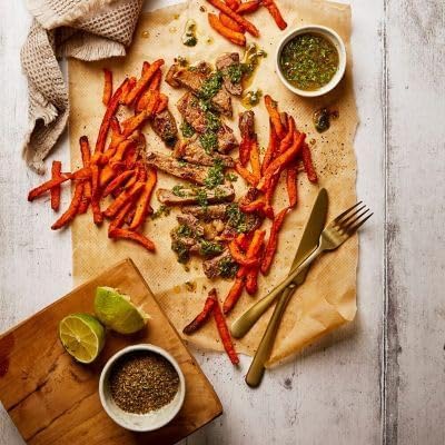Overhead view of sweet potato fries and steak cooked in an air fryer