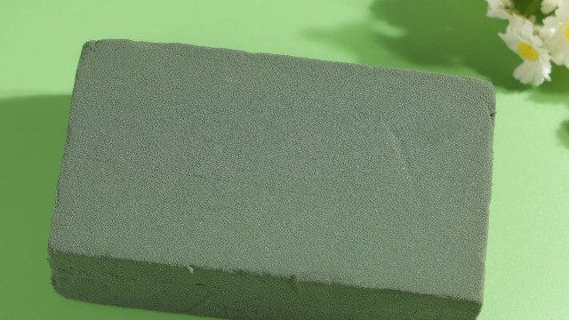 Floral foam being cut and soaked in water