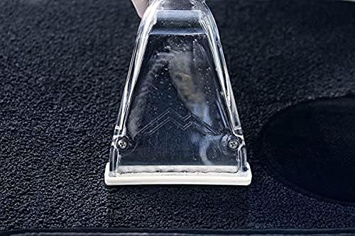 Upholstery tool being used to clean a dark carpet surface