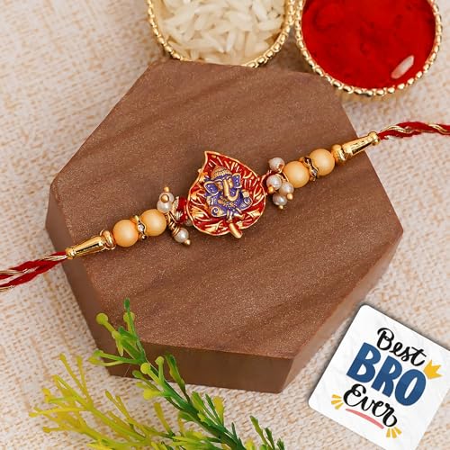 Image of eCraftIndia Golden, Red & Purple Lord Ganesha On Leaf Religious Rakhi, Wooden Cutout with Roli Chawal Pack - Rakhi for Brother, Bhaiya, Bhai