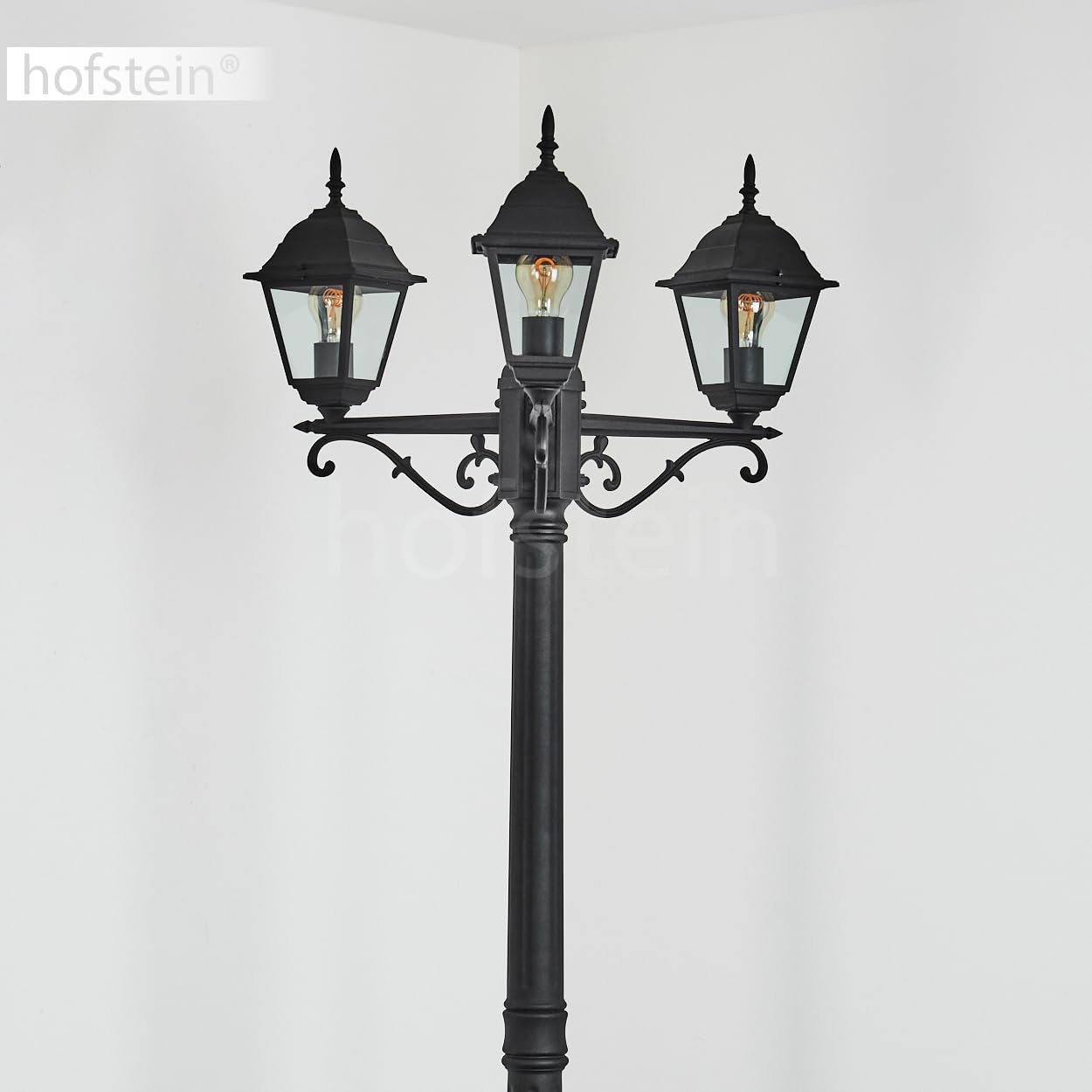 Close-up view of one of the HOFSTEIN Naofe lamp heads, showing the E27 bulb socket and clear glass panels.