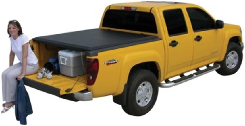 Woman sitting on tailgate with Access Roll-up Tonneau Cover installed
