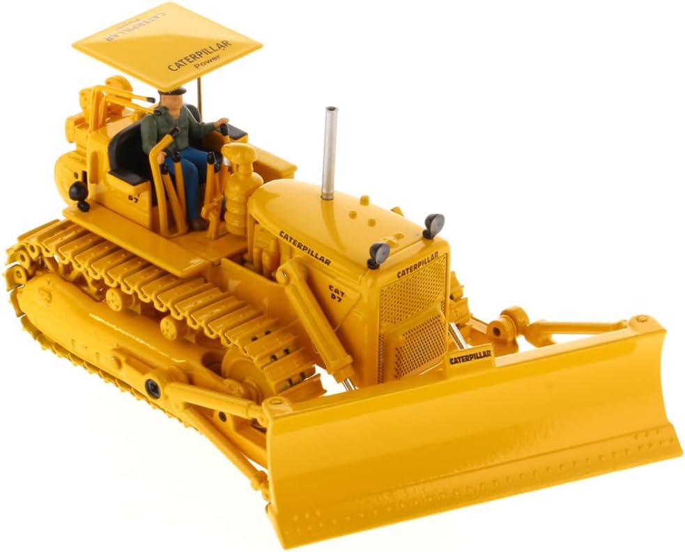 O'r brig i lawr view of the Diecast Masters Caterpillar D7C Track Type Tractor's cab, showing the detailed interior and the included operator figure.