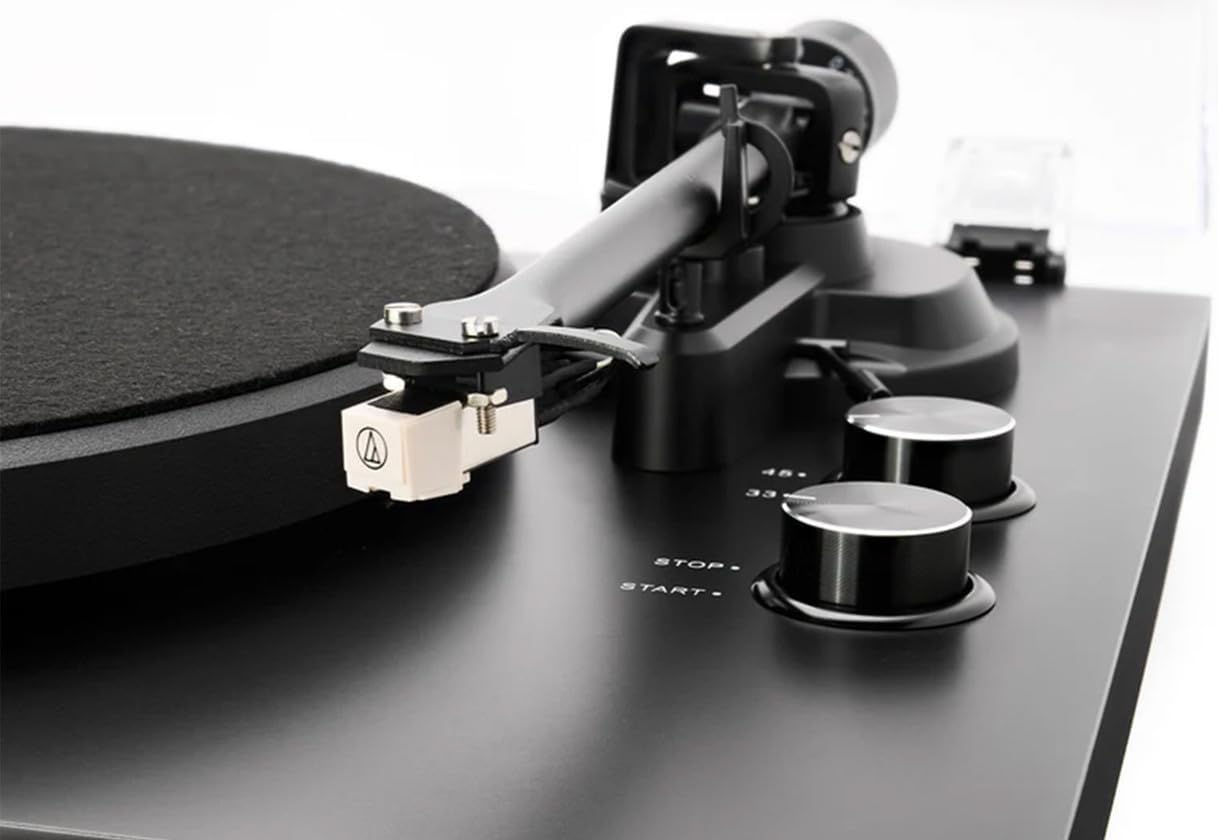 Close-up of turntable cartridge and speed selection knobs