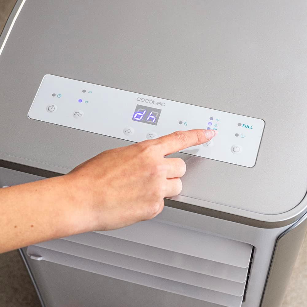 Finger touching the control panel of the air conditioner