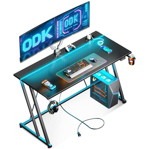 ODK 120 × 50 cm Mesa Gaming con Luces LED y Toma de Corriente, Escritorio Gaming con Soporte para Taza y Gancho para Auriculares, Diseño Doble Z Mesa Mesa Ordenador Fibra de Carbono Negro