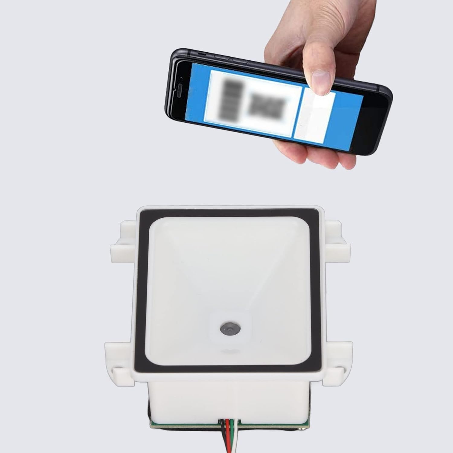 A hand holding a smartphone displaying a barcode, positioned above the Jectse Mini Barcode Scanner for scanning.