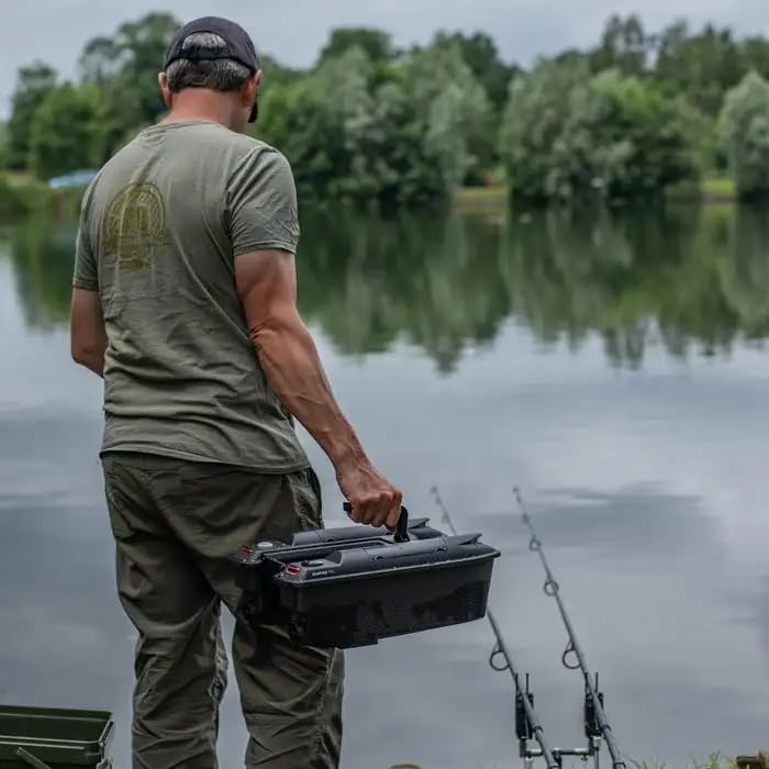 Man holding Ridgemonkey Hunter 750 Bait Boat by a lake