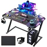 Claiks Bureau Gaming avec RGB LED, 120x60 cm, Surface en Fibre de Carbone, Bureau avec Porte-Boisson, Crochet pour Casque, Table d'ordinateur Stable Z-Frame, Noir