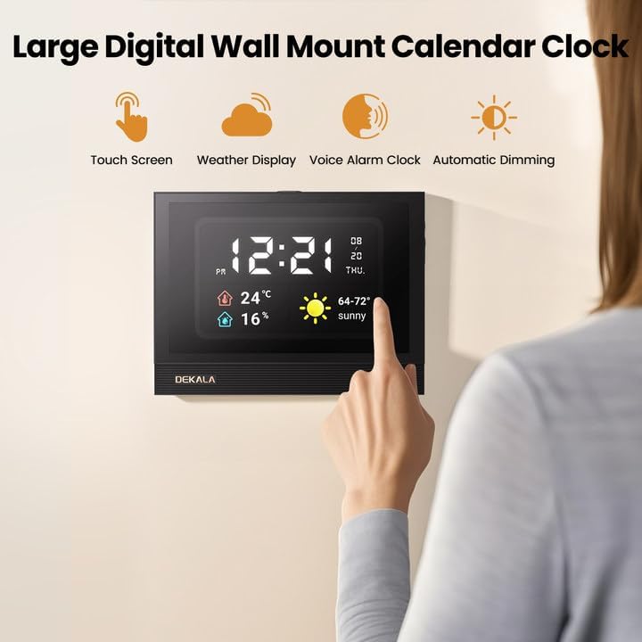 A person pointing at a Dekala ClearTime clock mounted on a wall, displaying time, date, and weather.