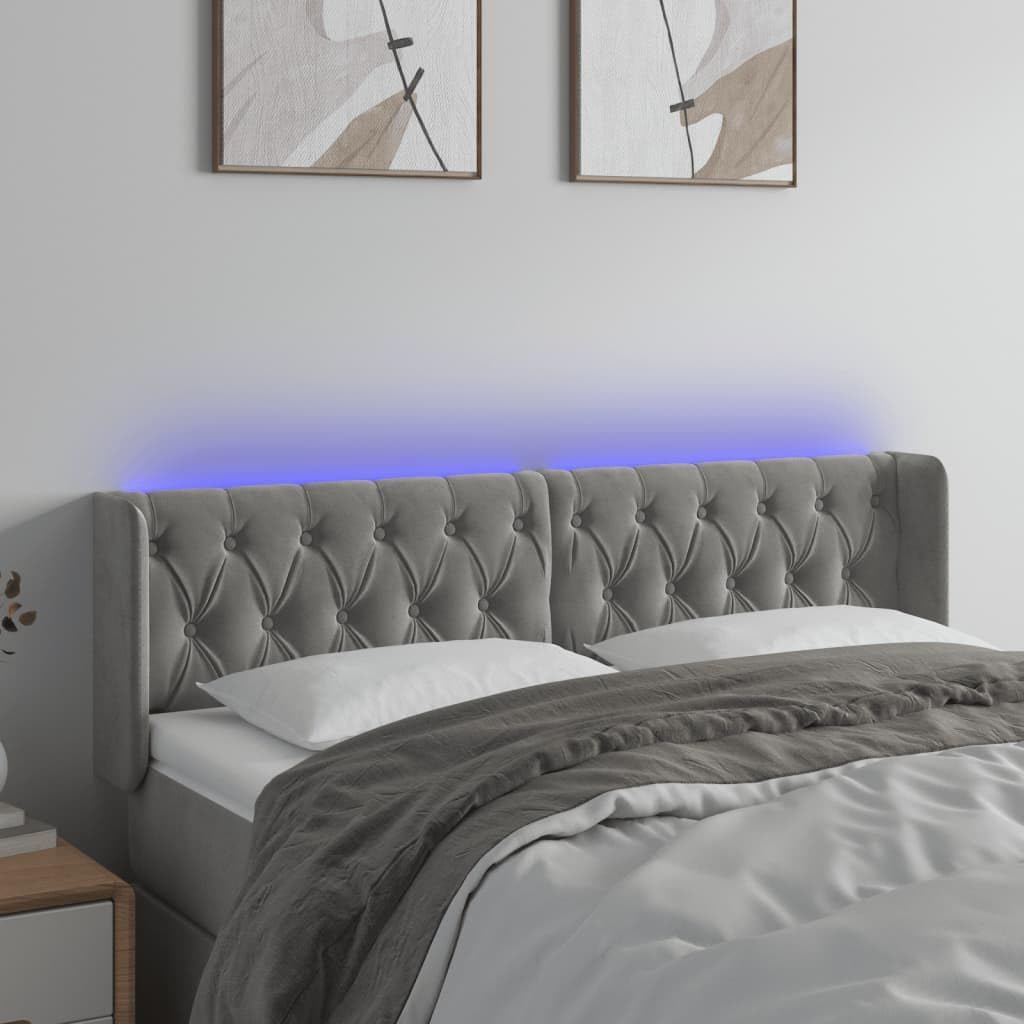 A bed with the vidaXL LED headboard installed, showing the blue LED lights illuminated along the top edge.