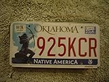OK-104 Oklahoma Native America license plate red numbers on white with Native American shooting bow and arrow flat non-embossed