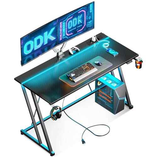 ODK Mesa Gaming, Escritorio Gaming con Luces LED y Toma de Corriente, Mesa Gamer con Soporte para Taza y Gancho para Auriculares, Diseño Doble Z Mesa Escritorio Ordenador Fibra de Carbono Negro 120 cm