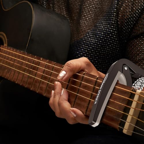 Image of Amazon Basics Guitar Capo with Pin Remover | Heavy Duty ABS Material | Versatile Fit | For Acoustic & Electric Guitar, Ukulele and Banjo | Buzz Free (Black)