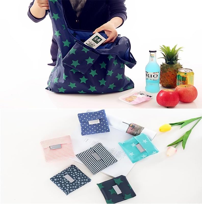 A person placing items into a dark blue reusable grocery bag with green stars, next to various groceries like fruit and drinks.