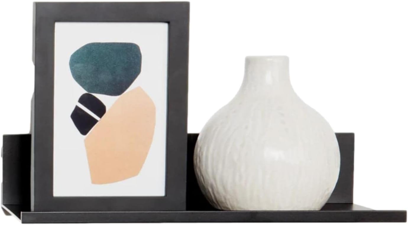 Black floating shelf displaying a framed picture and a white vase