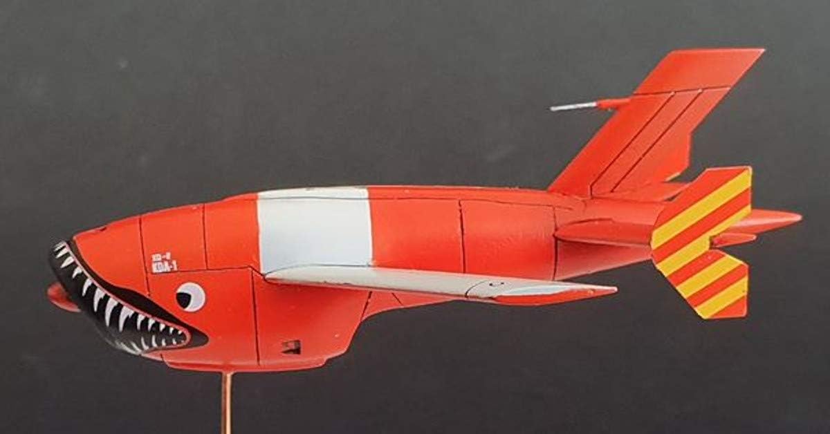 Side view of the assembled KDA-1 Firebee model, showing its sleek profile, red and white color scheme, and detailed tail section.