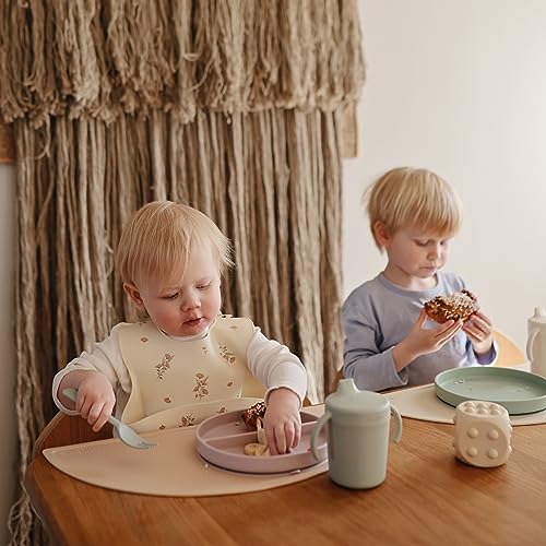 Image of mushie Silicone Baby Bib | Adjustable Fit Waterproof Bibs (Pink Flowers)