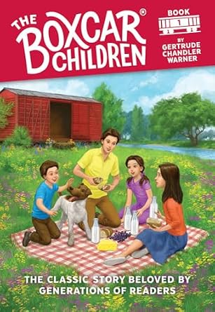 The Boxcar Children first book book cover featuring the four children having a picnic behind on a picnic blanket with a dog, the boxcar in the background, and a lake.