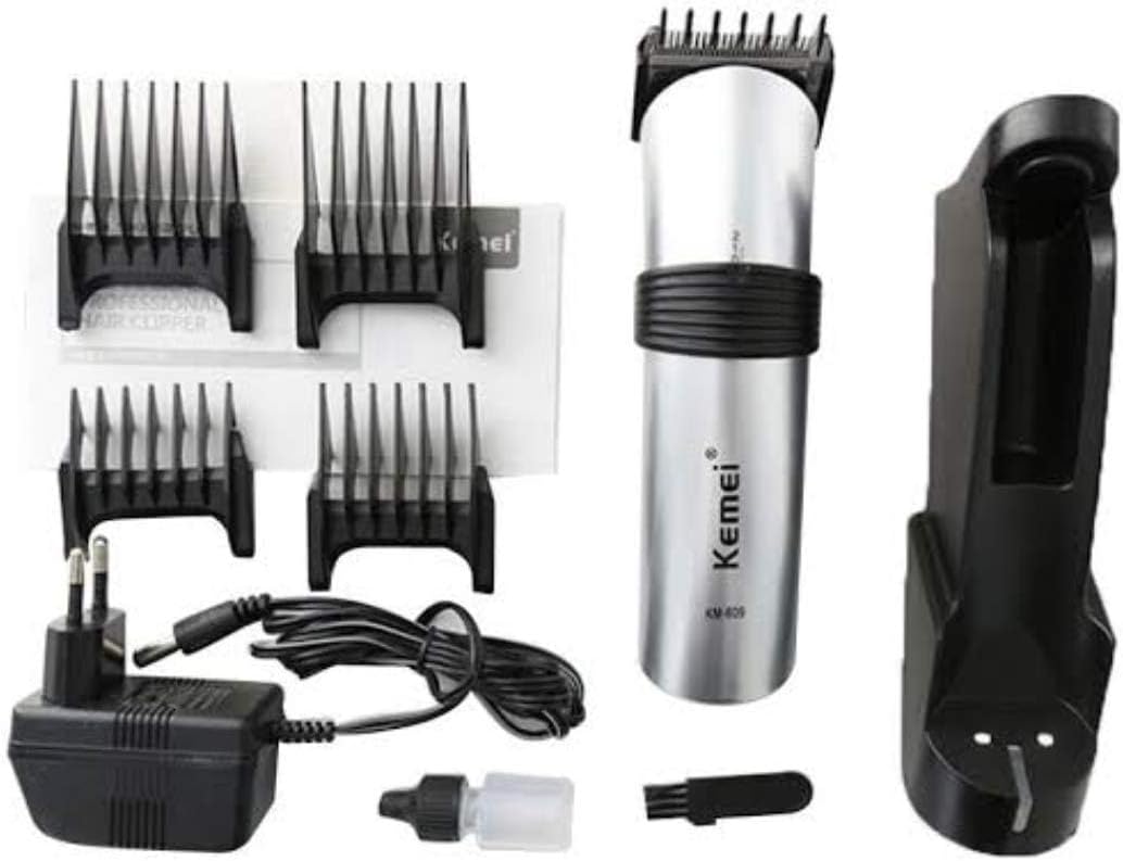KEMEI KM-609 shaver components including the shaver, charging dock, power adapter, guide combs, cleaning brush, and oil bottle