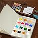 Mini Paint Palette Travel Kit - 15-Colors Pocket Artist Water Color Travel Set with Crossbody Bag, Watercolor Journal, Metal Clip, Paint Water Cup, Water Brush, Wooden Paint Box for Painters Artists