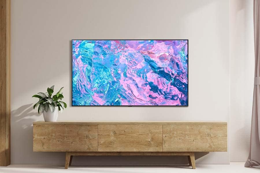 Samsung Crystal UHD CU7179 TV mounted on a wall in a living room.