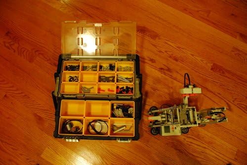Open storage case with various LEGO Mindstorms NXT 2.0 components organized.