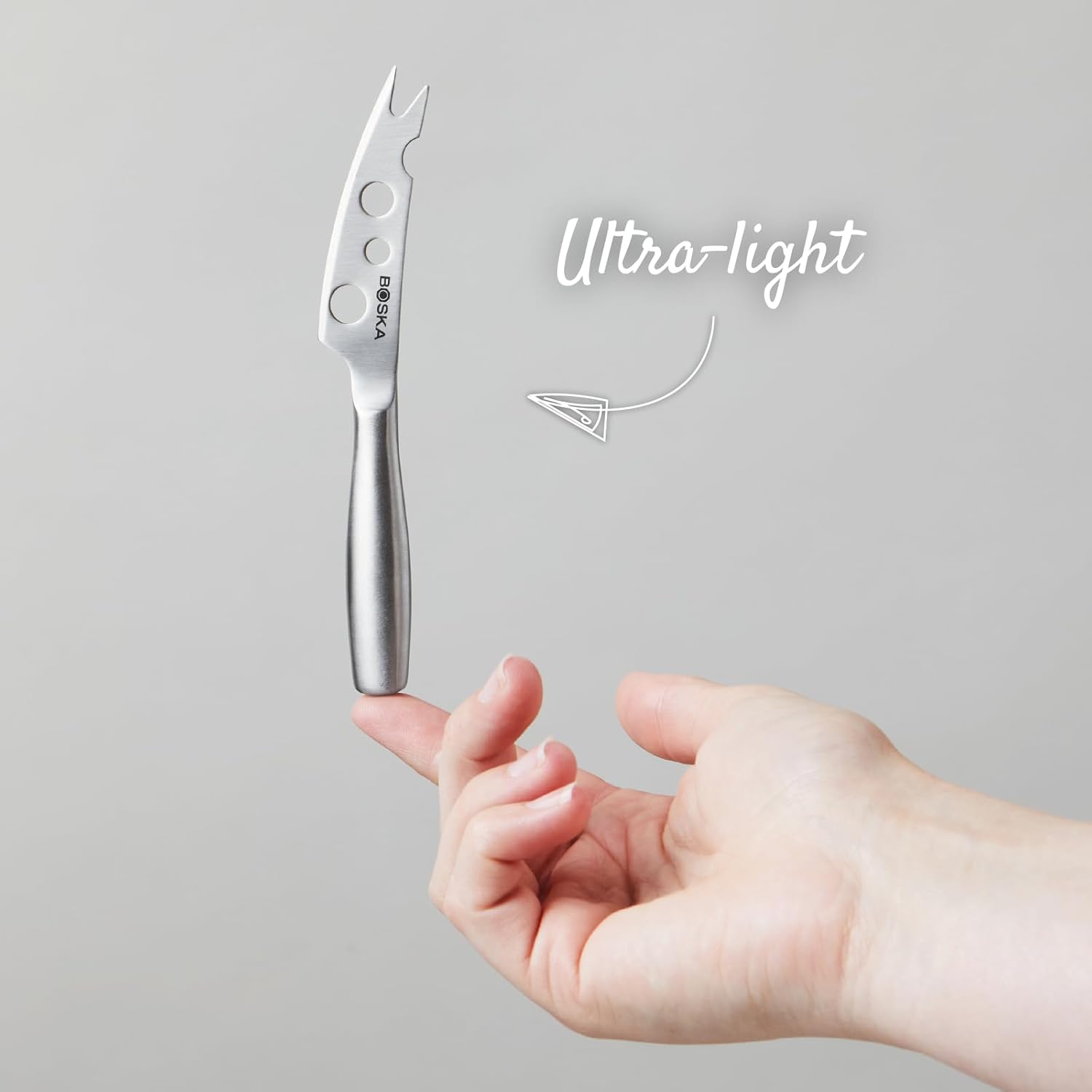 A BOSKA semi-soft cheese knife held upright, showcasing its perforated blade and fork tip.
