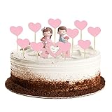 ✿ Figura de pastel de bodas: el novio lleva un traje gris y sostiene flores; la novia lleva un vestido rosa con un lazo rosa y sostiene un corazón, la novia y el novio están sentados espalda con espalda en forma de corazón.