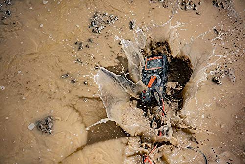 Sonel CMM 30 Multimeter splashing into a puddle of mud, showcasing its water resistance and durability.