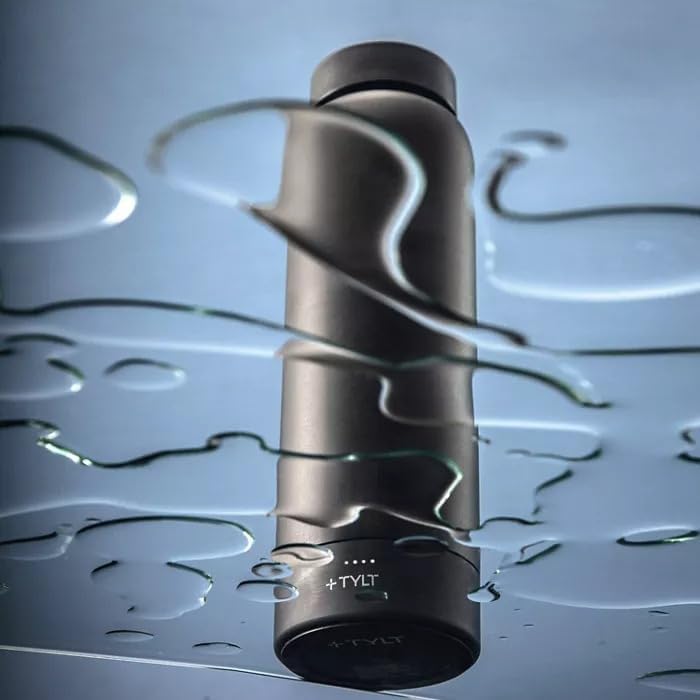 The TYLT Power Bottle 2.0 standing on a wet surface, demonstrating its waterproof power bank base.