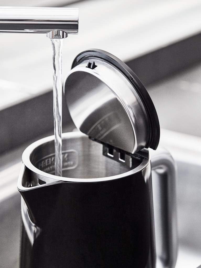Tefal KO851 kettle being filled with water from a tap