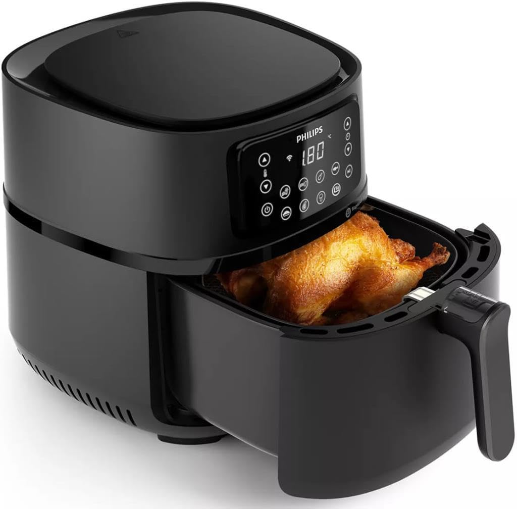 Philips Airfryer with the cooking basket pulled out, containing a roasted chicken