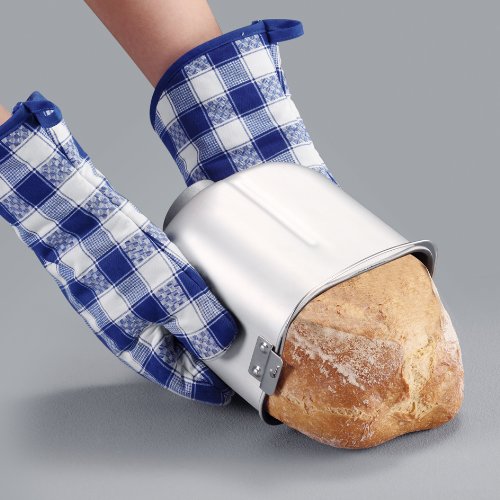 Hands wearing oven mitts removing baked bread from the pan