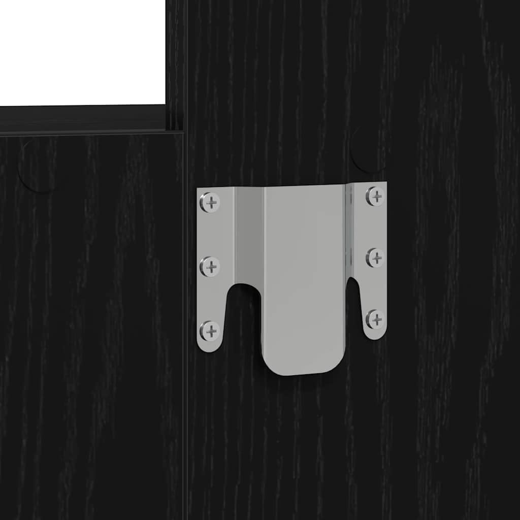 Close-up of a metal wall mounting bracket with screws, attached to a black wood surface