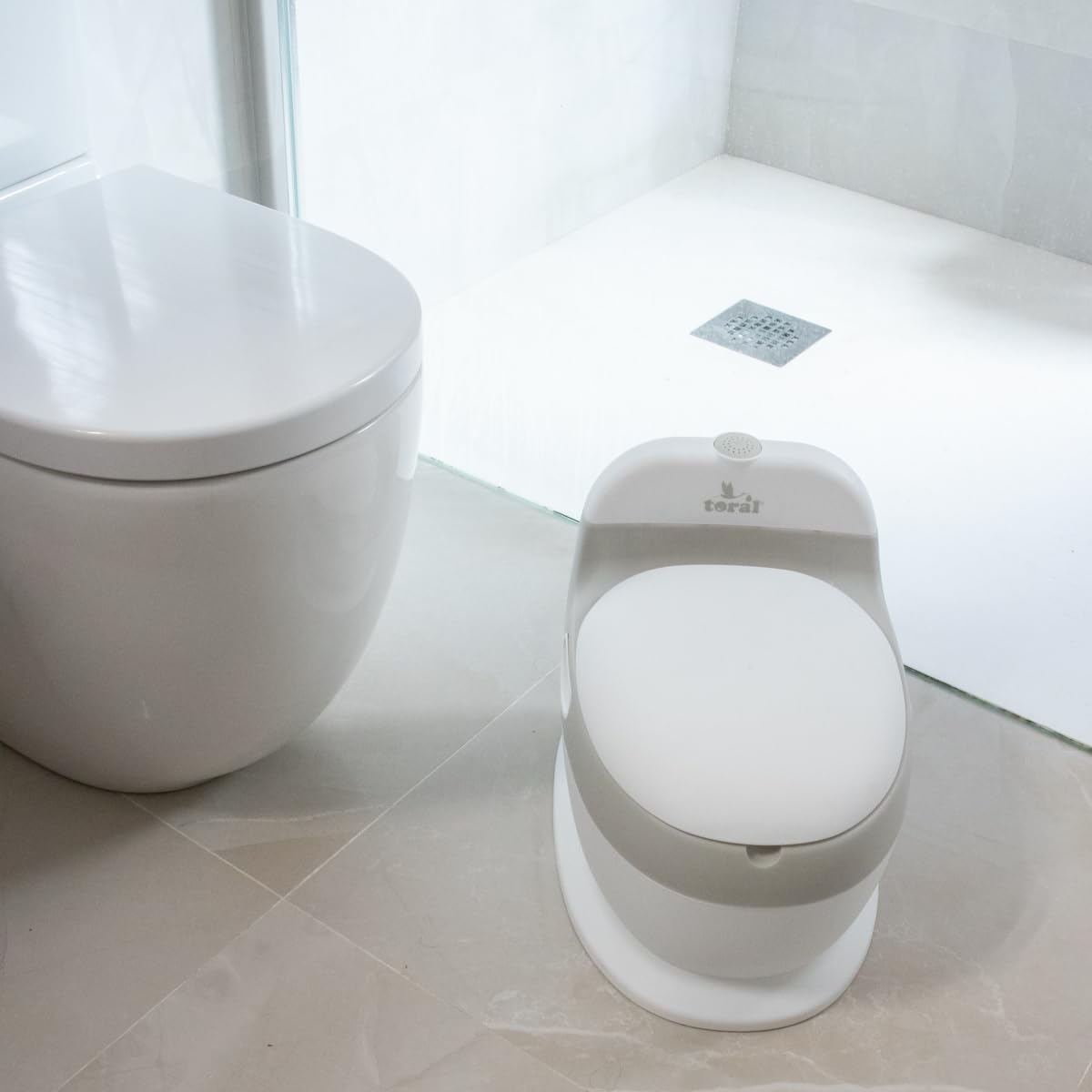 TORAL Orinal Bebe Musical Acolchado. Inodoro portatil handy potty. Ayuda al aprendizaje de bebés y niños. Perfecto como orinal bebe 2 años o baño portatil. Orinal portatil con sonido incluido. +18m