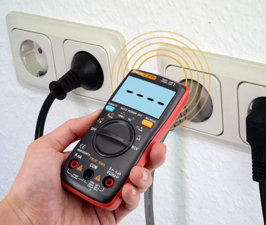 Hand holding ZT-111 multimeter near an electrical outlet for NCV detection
