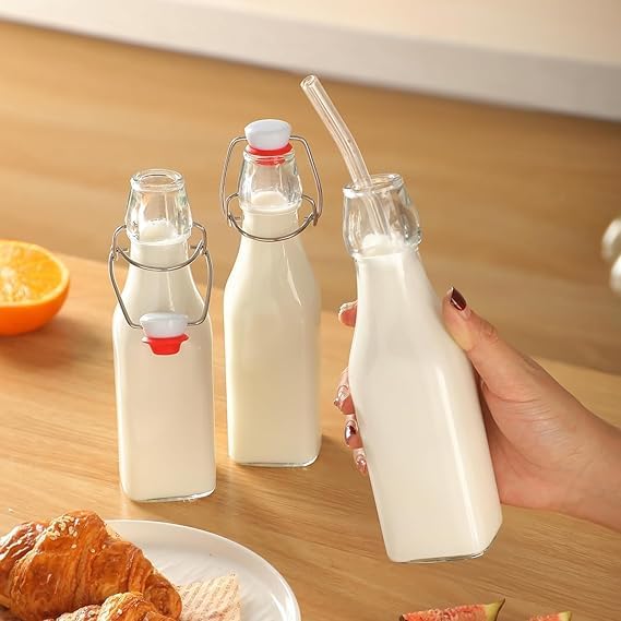 Image of Clear Glass Bottles with Airtight Swing Top Lids - Leakproof Reusable Glass Jars for Juices, Oil, Water, Kombucha, Milk, Vinegar, and Beverages (CLEAR, SQUARE PACK OF 4)