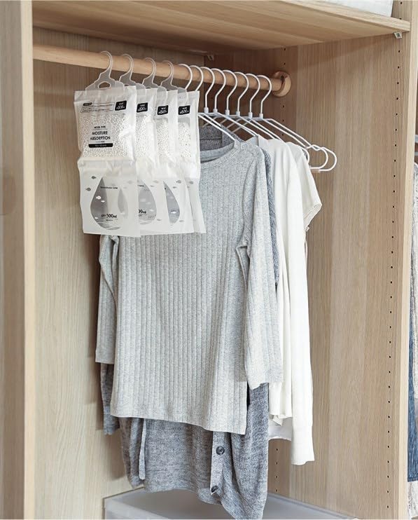 Bodepot Hanging Dehumidifier Bags hanging alongside clothes in a closet.