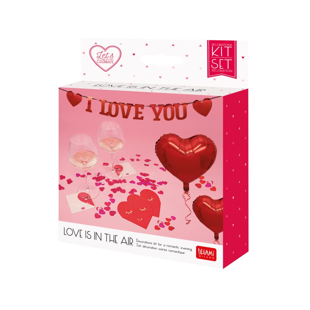 Close-up of the 'I Love You' paper garland with heart accents, hung against a pink background.