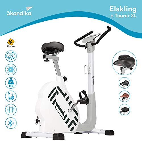 skandika Elskling - Vélo d'appartement - Différentes selles - Inertie 11 kg - 24 Prog. - Support Tablette - Bluetooth (Blanc avec Selle Randonnée)