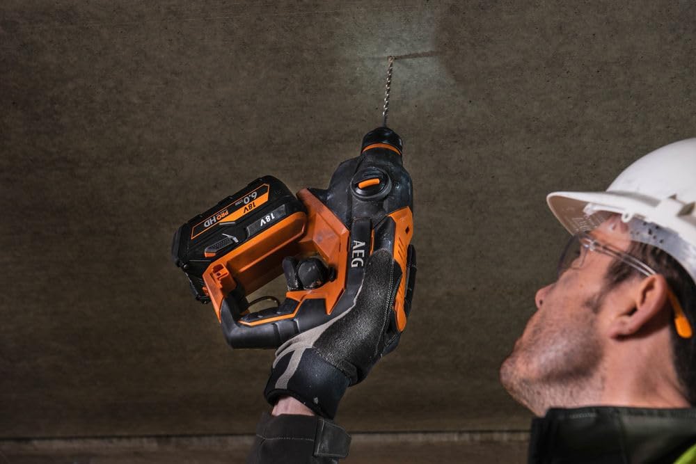 User operating AEG 18V Brushless Rotary Hammer on a concrete ceiling
