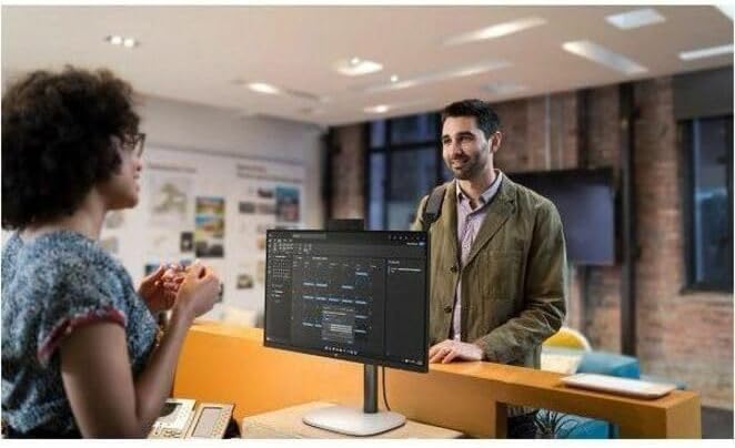 People interacting with the HP ProStudio 4 AiO G1i in an office setting